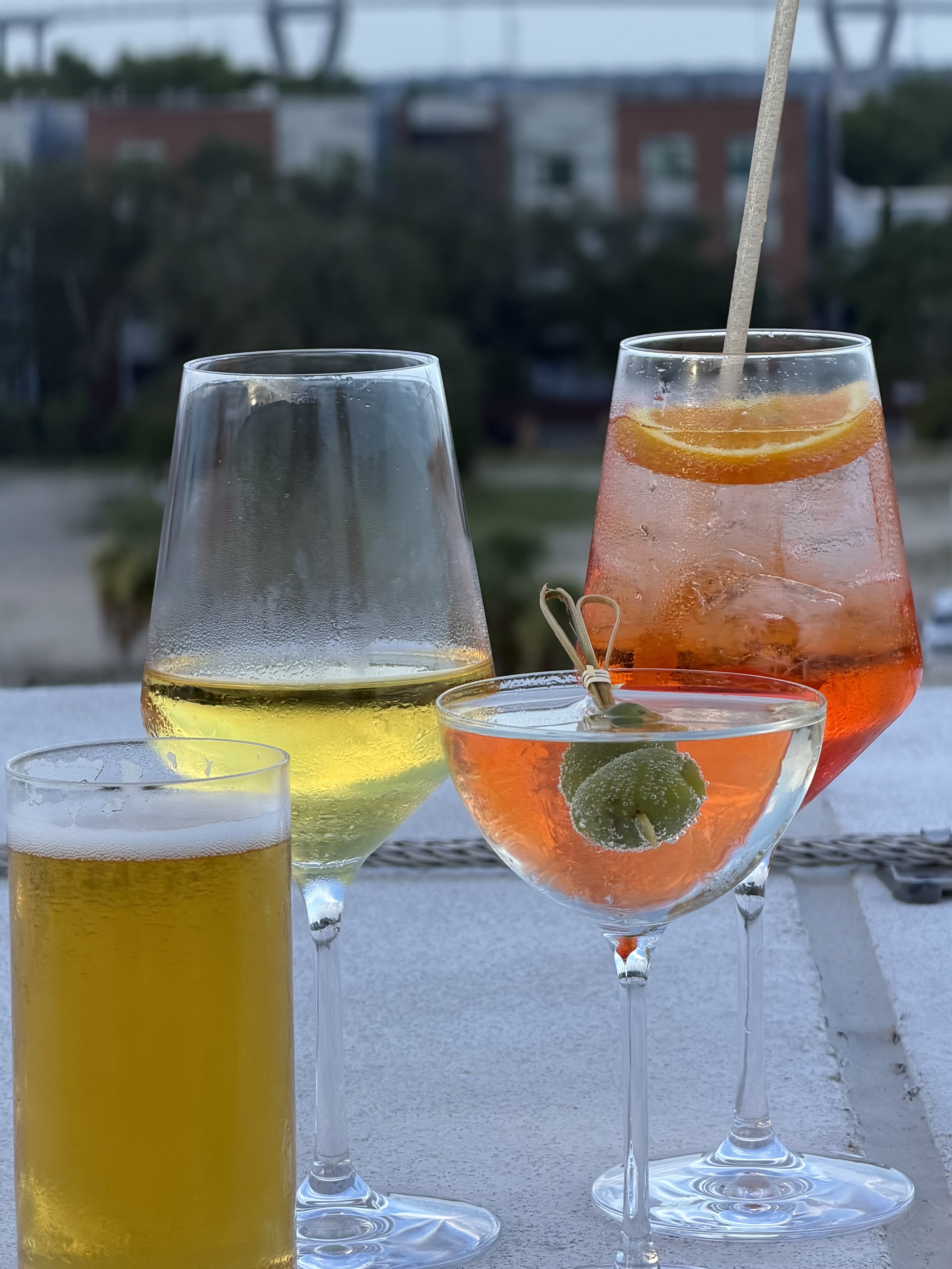 Cocktails at golden hour on a Charleston rooftop, with the Ravenel Bridge in the distance