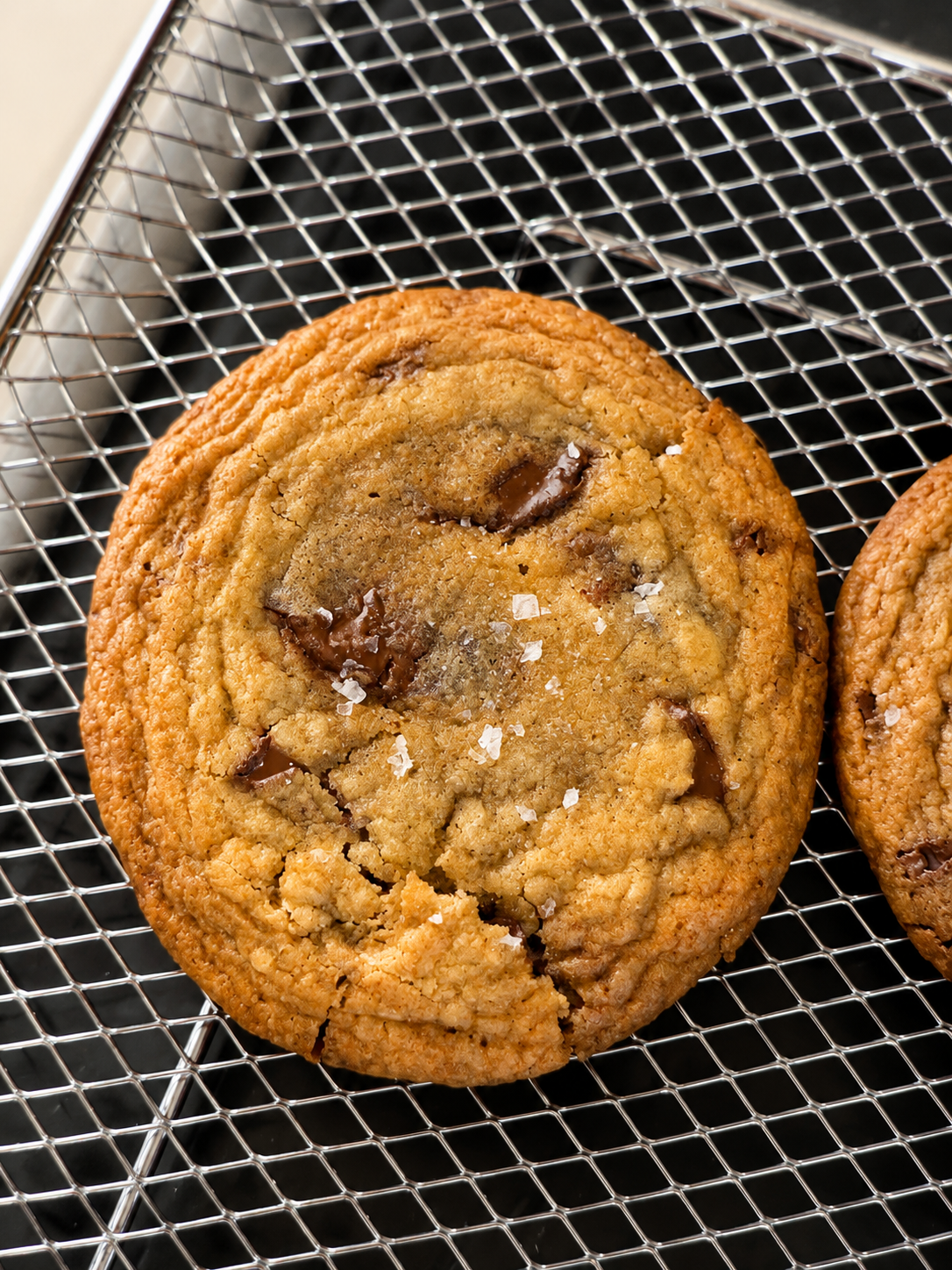 A fresh-baked chocolate chip cookie with flaky salt