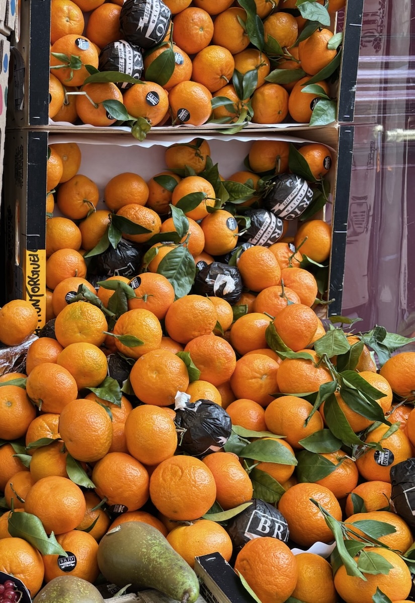 Crates of fresh oranges at a market