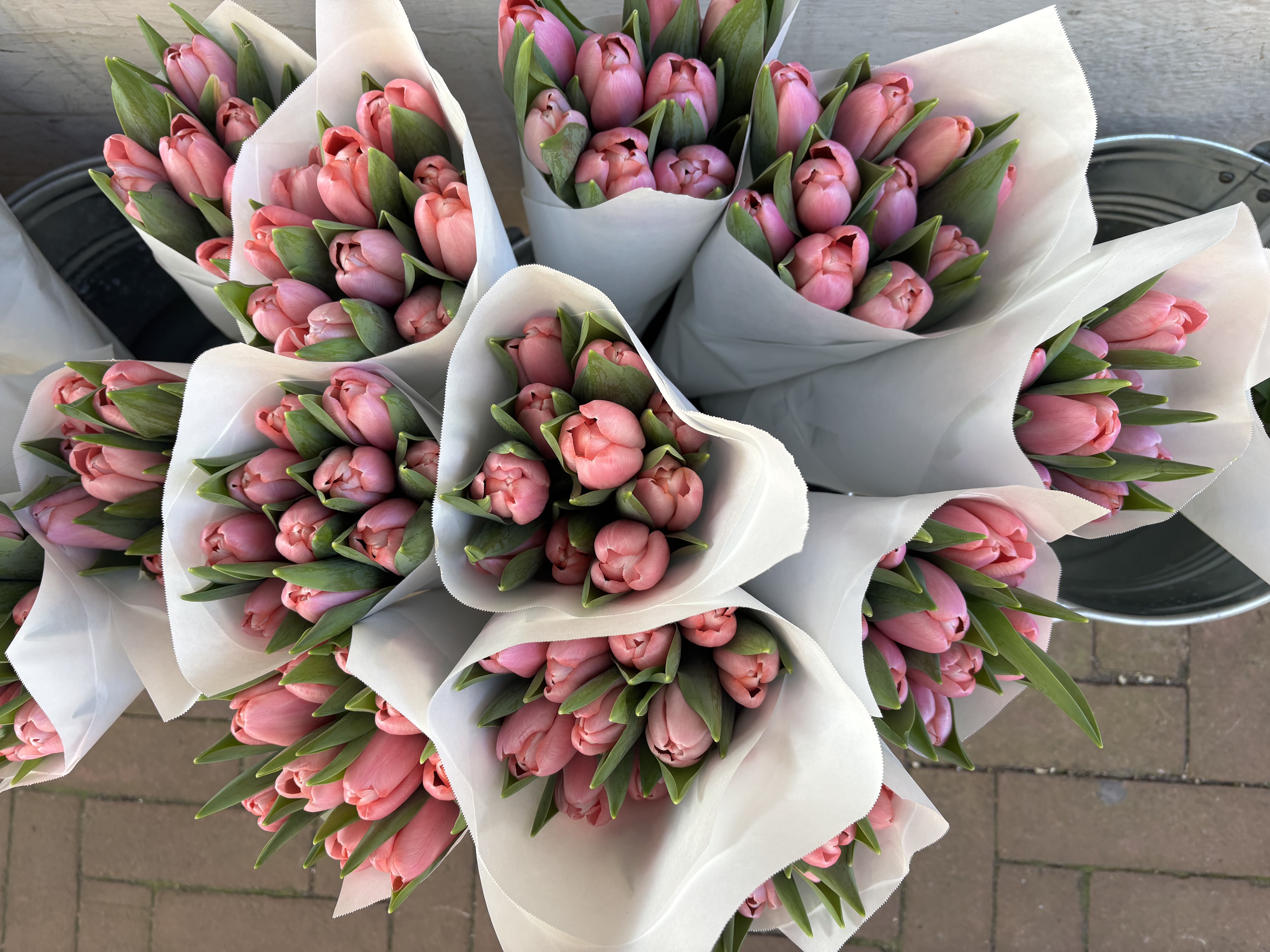 Bouquets of tulips wrapped in paper at a flower market